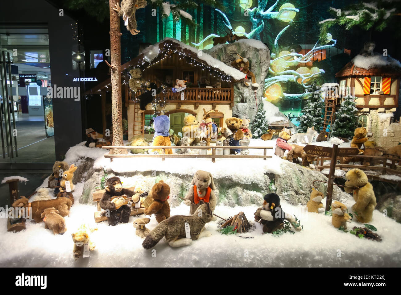 MUNICH, GERMANY - DECEMBER 11, 2017 : The shop window of Galeria Kaufhof ornated with toys in winter style at night in Munich, Germany. Stock Photo