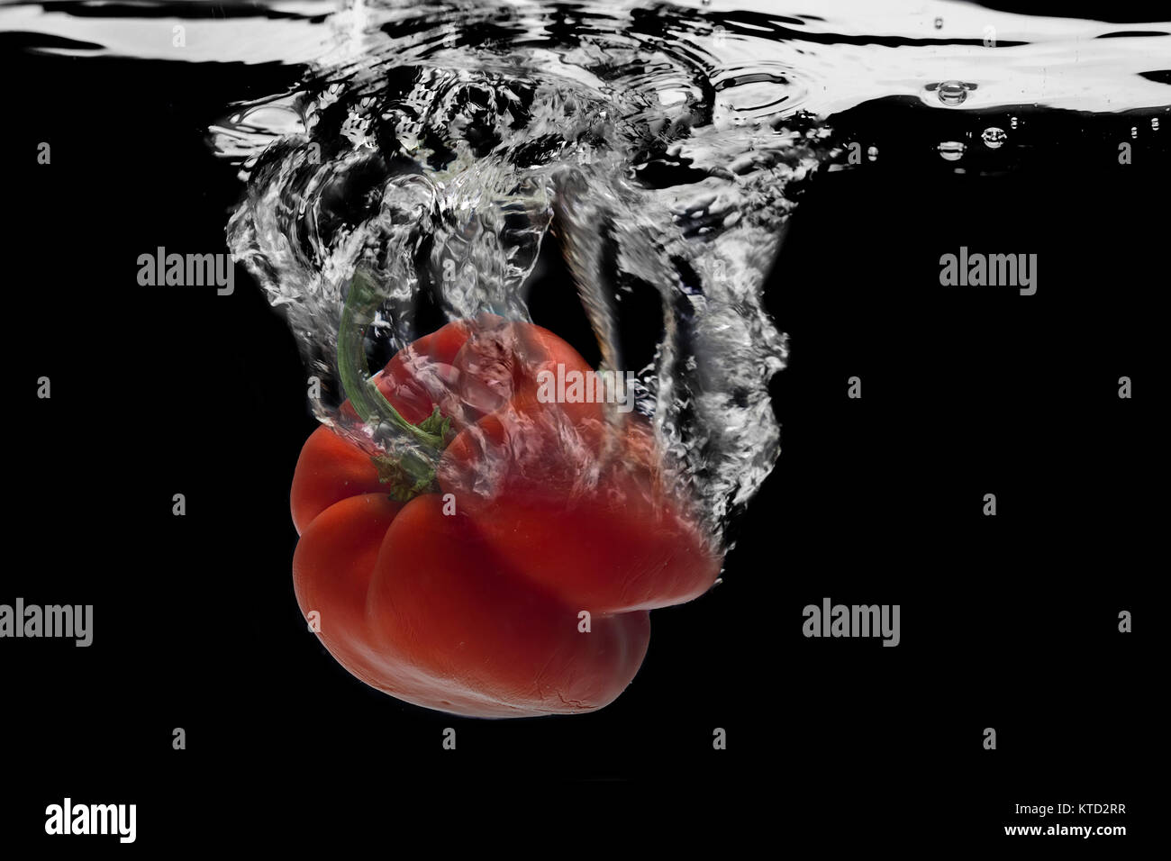 Red pepper,  water splash. Stock Photo