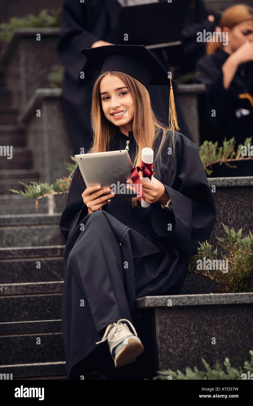 Pretty young graduate with collegues, teamwork, diploma Stock Photo - Alamy