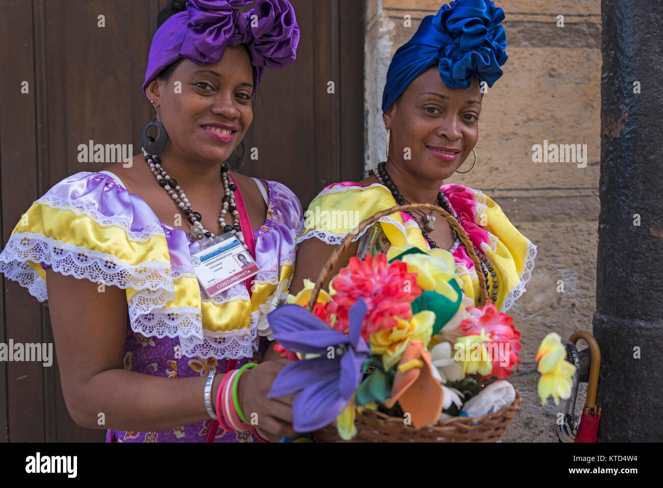 Two women dressed in traditional costumes in the streets of Havana, Cuba Stock Photo