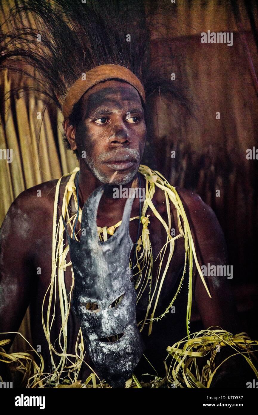 YOUW VILLAGE, ATSY DISTRICT, ASMAT REGION, IRIAN JAYA, NEW GUINEA, INDONESIA - MAY 23, 2016: Portrait of a man from the tribe of Asmat people with rit Stock Photo