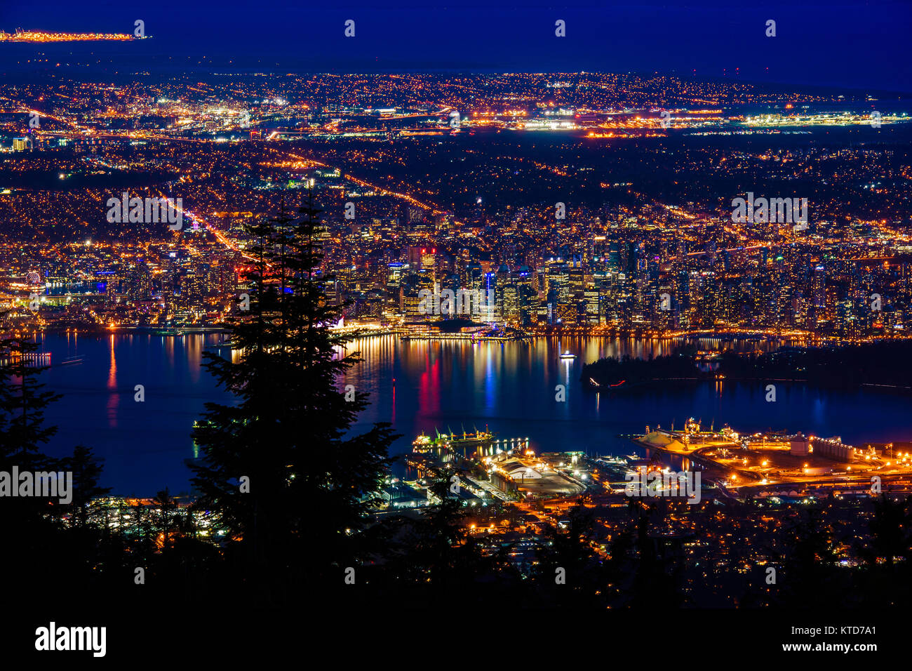 Aerial view of Vancouver city by night, British Columbia, Canada. Photographed from the top of the Grouse Mountain. Stock Photo