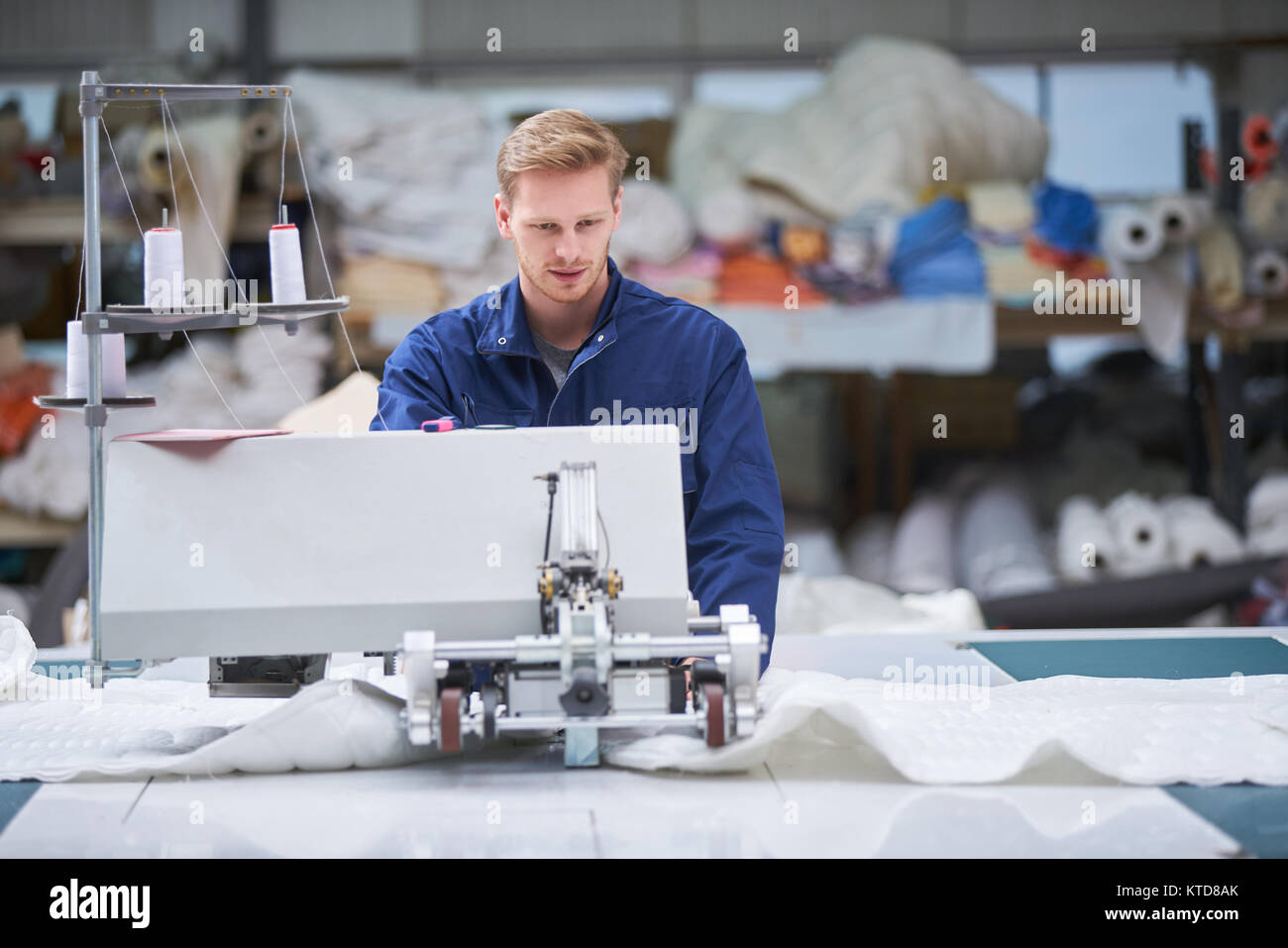 worker in protective clothing in factory using machine Stock Photo - Alamy