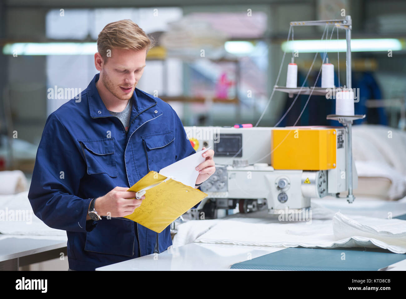 worker in protective clothing in factory using machine Stock Photo - Alamy