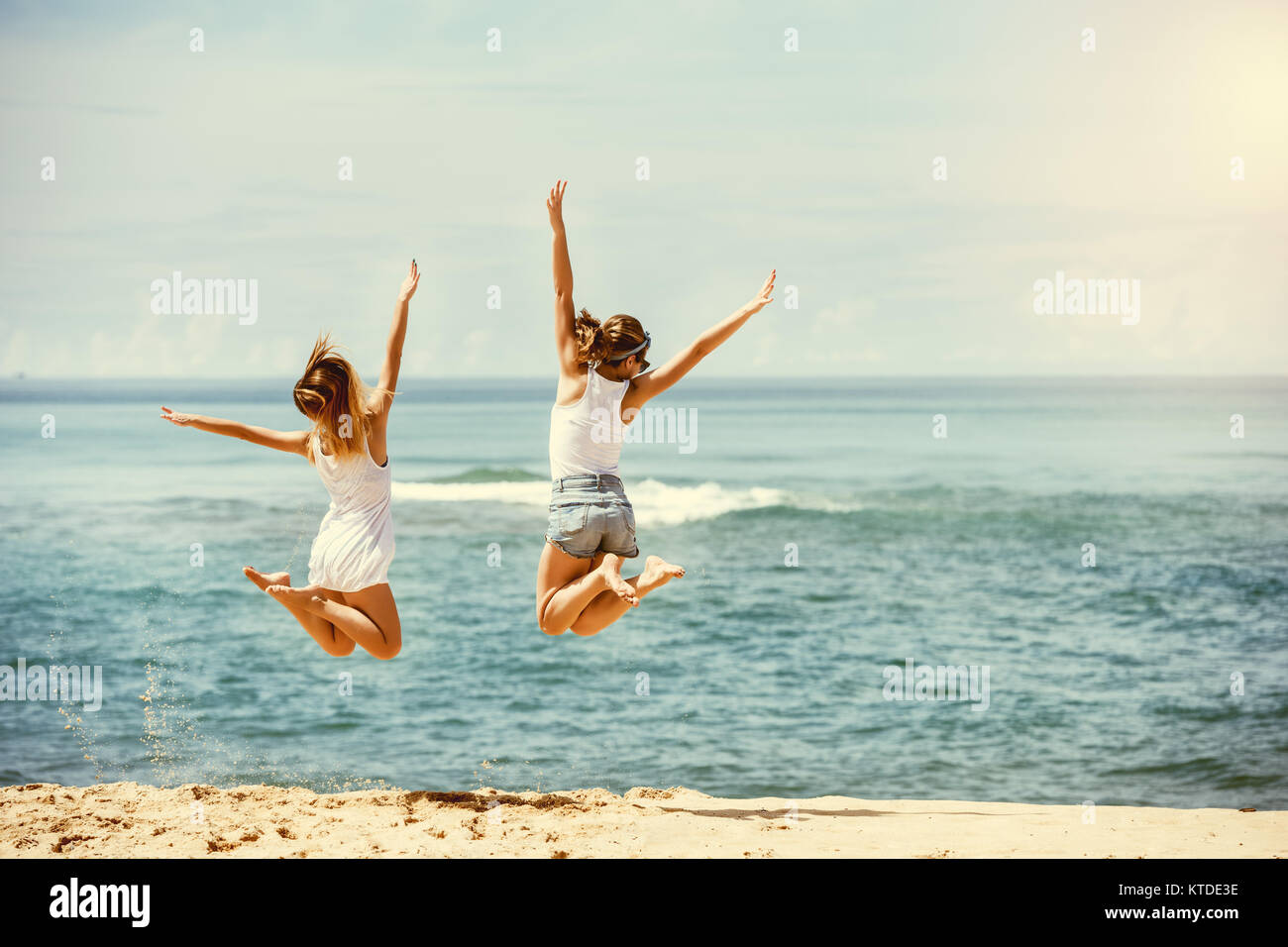 Two girls having fun jumping hi-res stock photography and images - Alamy