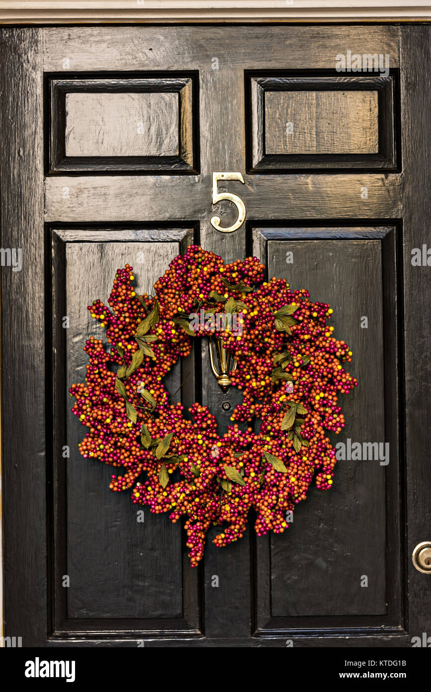 A Black Wooden Door Of A Historic Home Decorated With A Popcorn