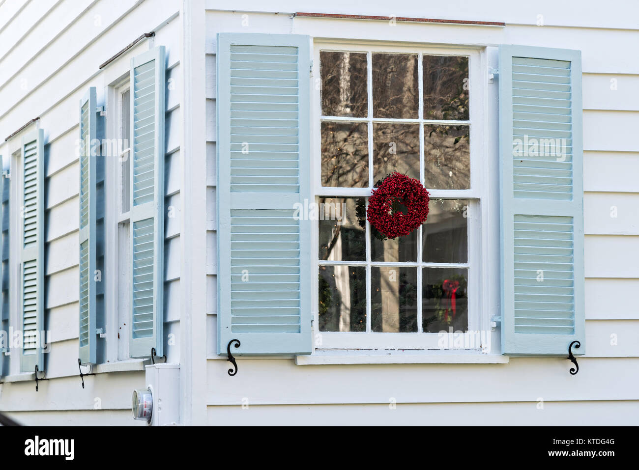 A Low Country Popcorn Berry Christmas Wreath Hangs From A Window