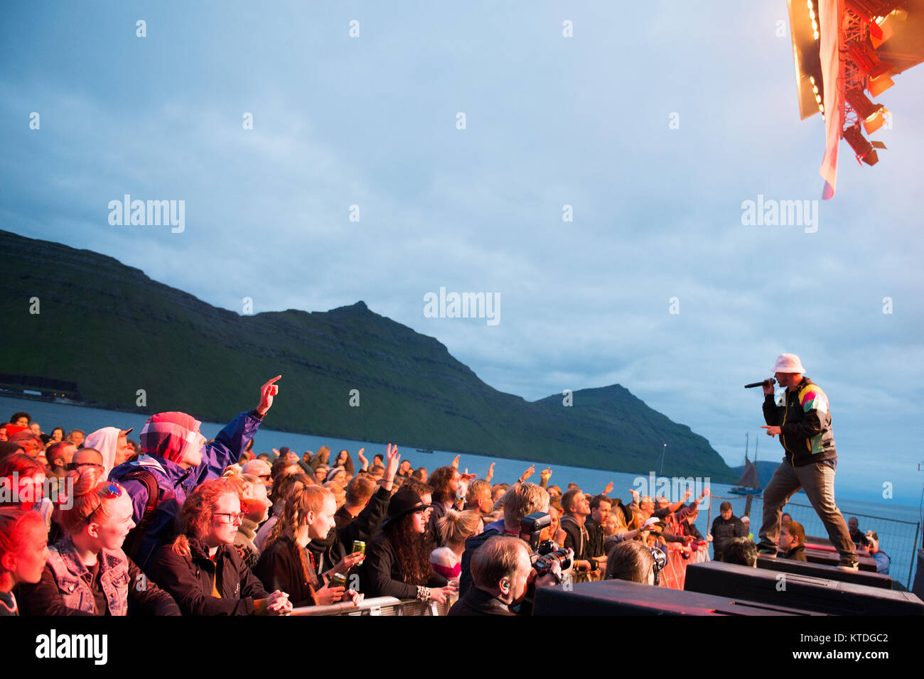 The legendary Danish rap group Malk De Koijn performs a live concert at the Faroese music festival G! Festival 2014. The group consists of Blæs Bukki, Geolo Geo and Tue Track (pictured). Faroe Islands 18.07.2014. Stock Photo