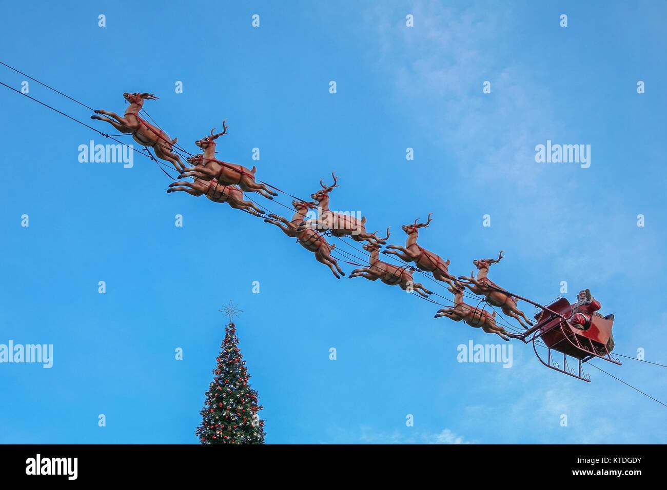 LOS ANGELES, CALIFORNIA, USA, NOVEMBER 26, 2006 - A figure of Santa Claus in his sleigh pulled by his reindeer adorns the sky of The Grove Mall. Stock Photo
