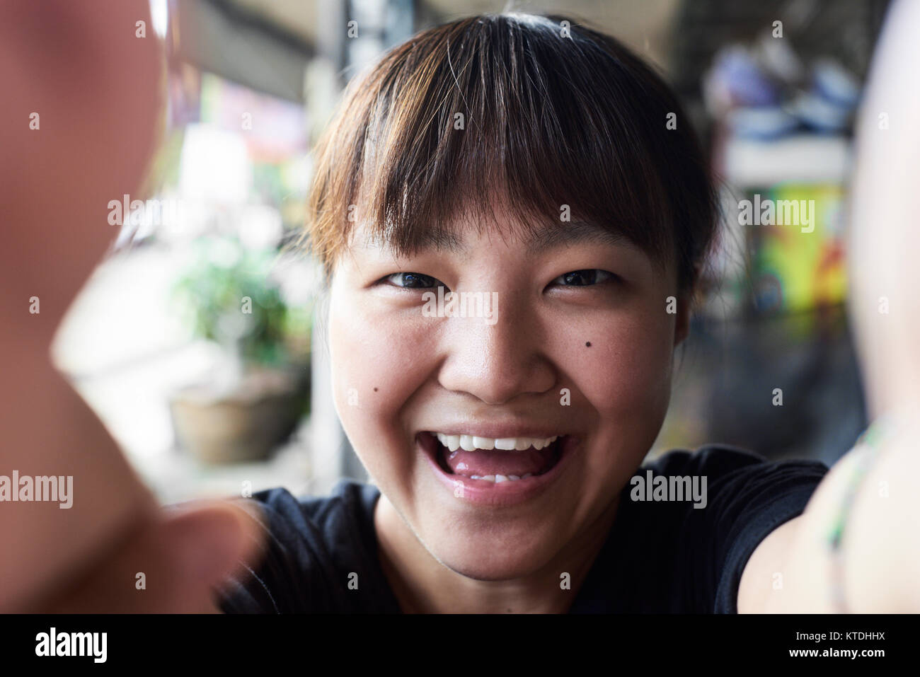 Attractive asian female enjoying time with her phone and taking self-portraits. Chiang Mai, Thailand. Stock Photo