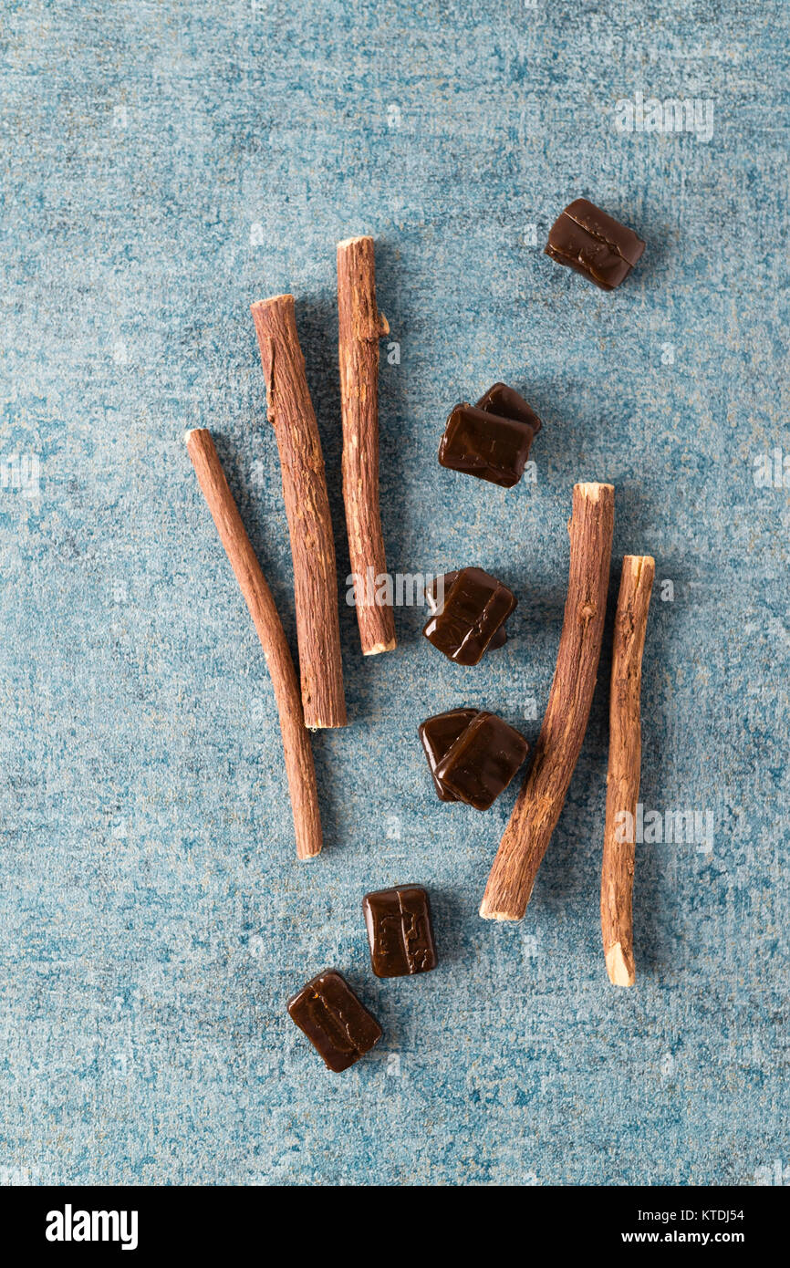 Licorice candies and liquorice root Stock Photo