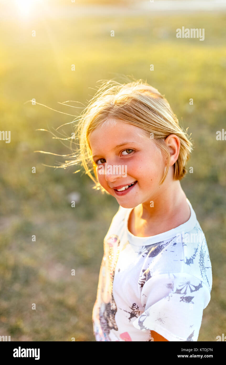 Portrait of smiling blond girl at backlight Stock Photo - Alamy