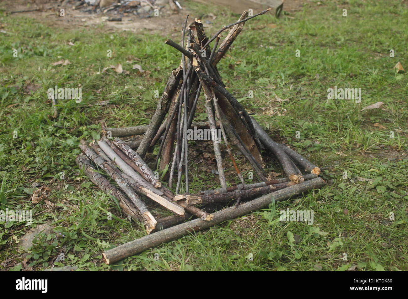 campground fire pit ready to burn using branches in the form of a