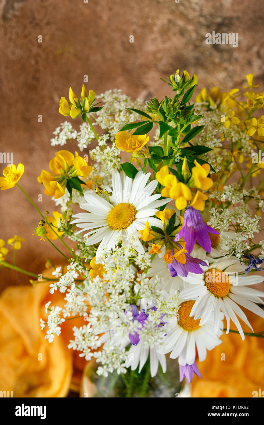 Bouquet of wild flowers in glass bottle Stock Photo - Alamy