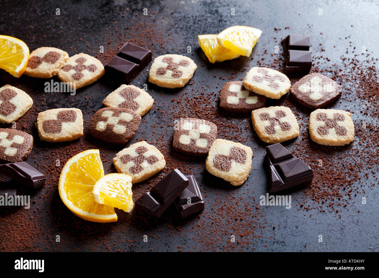 Black and white short crust Christmas cookies with orange slices and dark chocolate Stock Photo