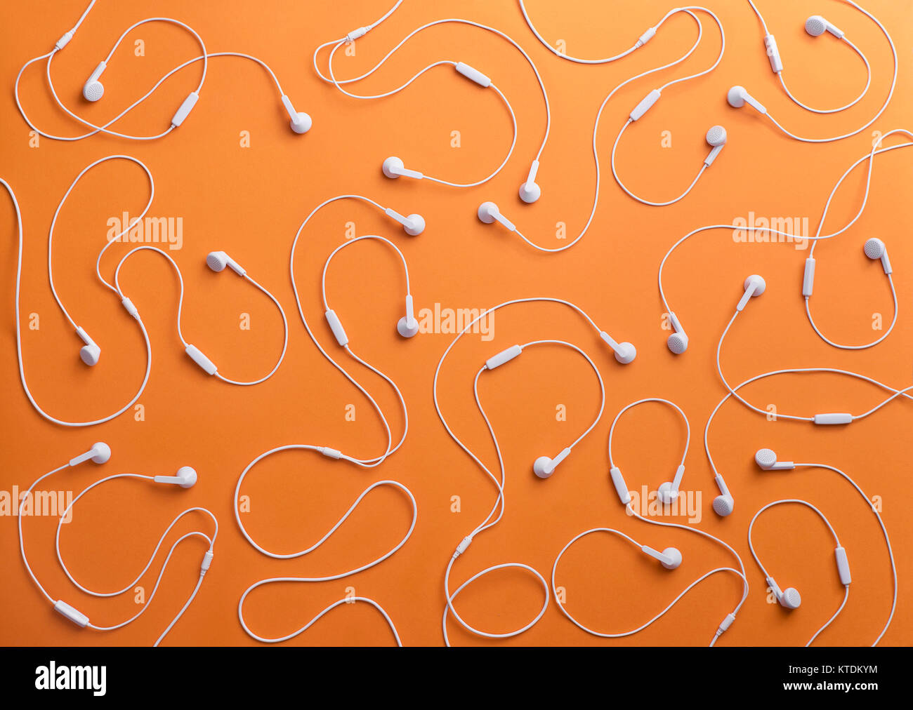 White earphones on orange background, 3D Rendering Stock Photo