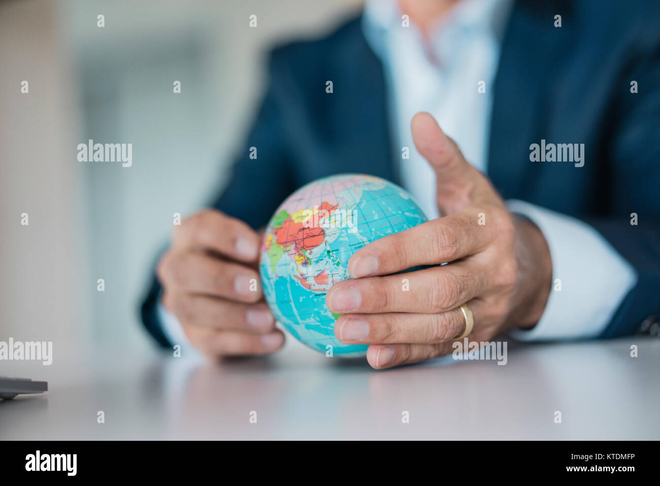 Close-up of hands of businessman holding globe Stock Photo