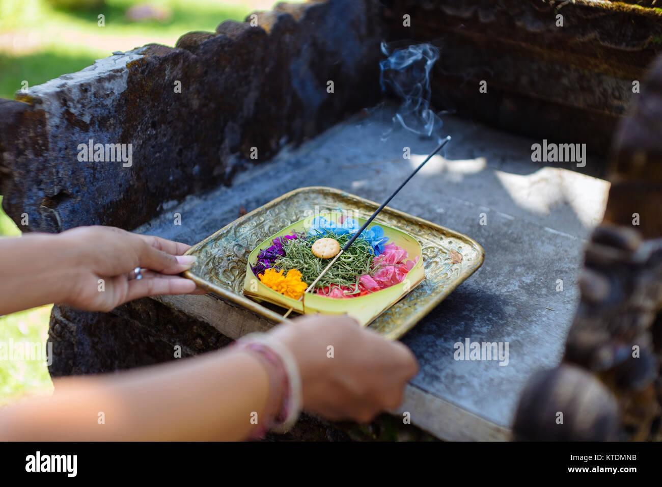 Woman serving Balinese offering Stock Photo