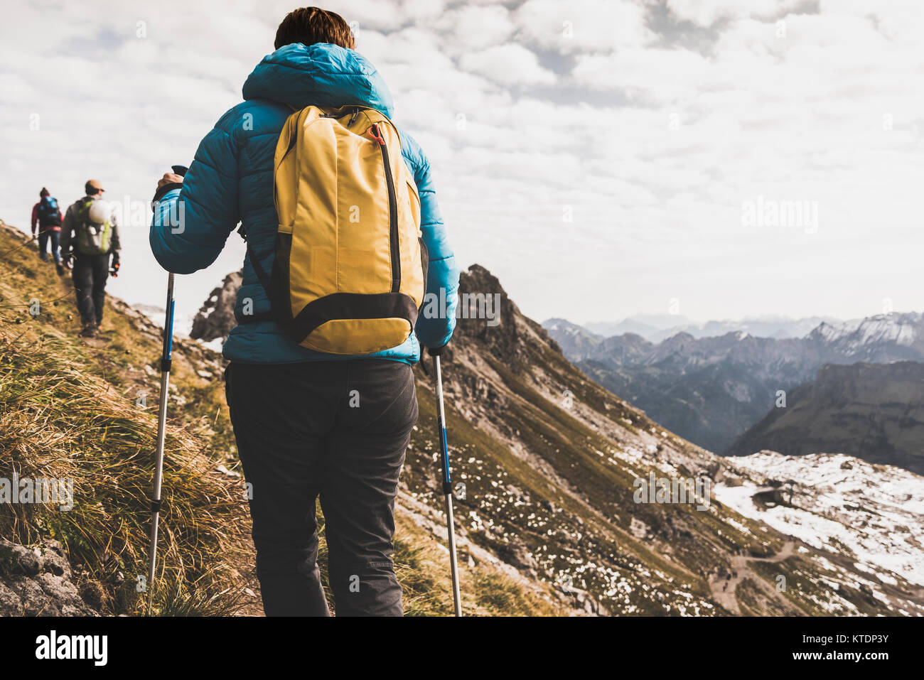 Germany, Bavaria, Oberstdorf, hikers walking in alpine scenery Stock Photo