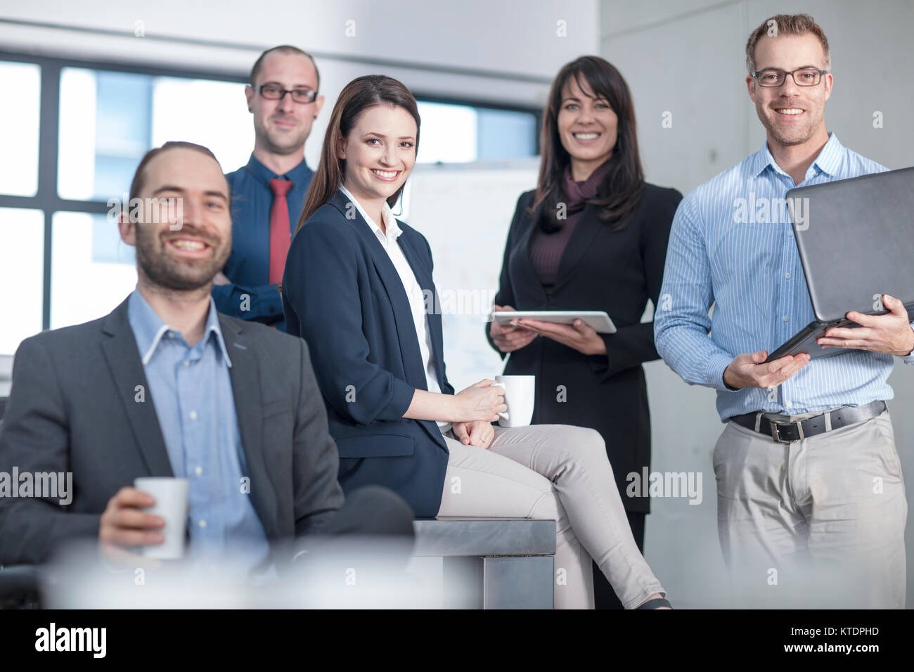 Portrait of smiling business team in office Stock Photo - Alamy
