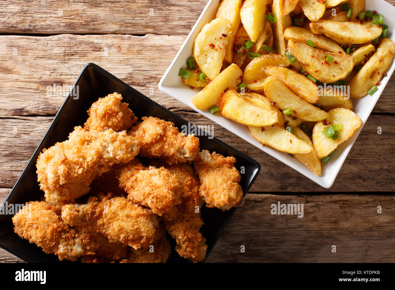 Delicious food deepfried chicken wings in breadcrumbs and potato