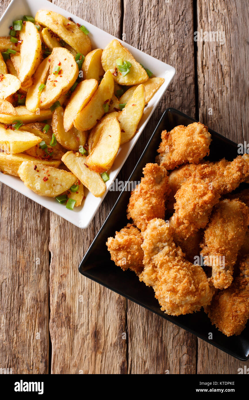 Delicious food deepfried chicken wings in breadcrumbs and potato