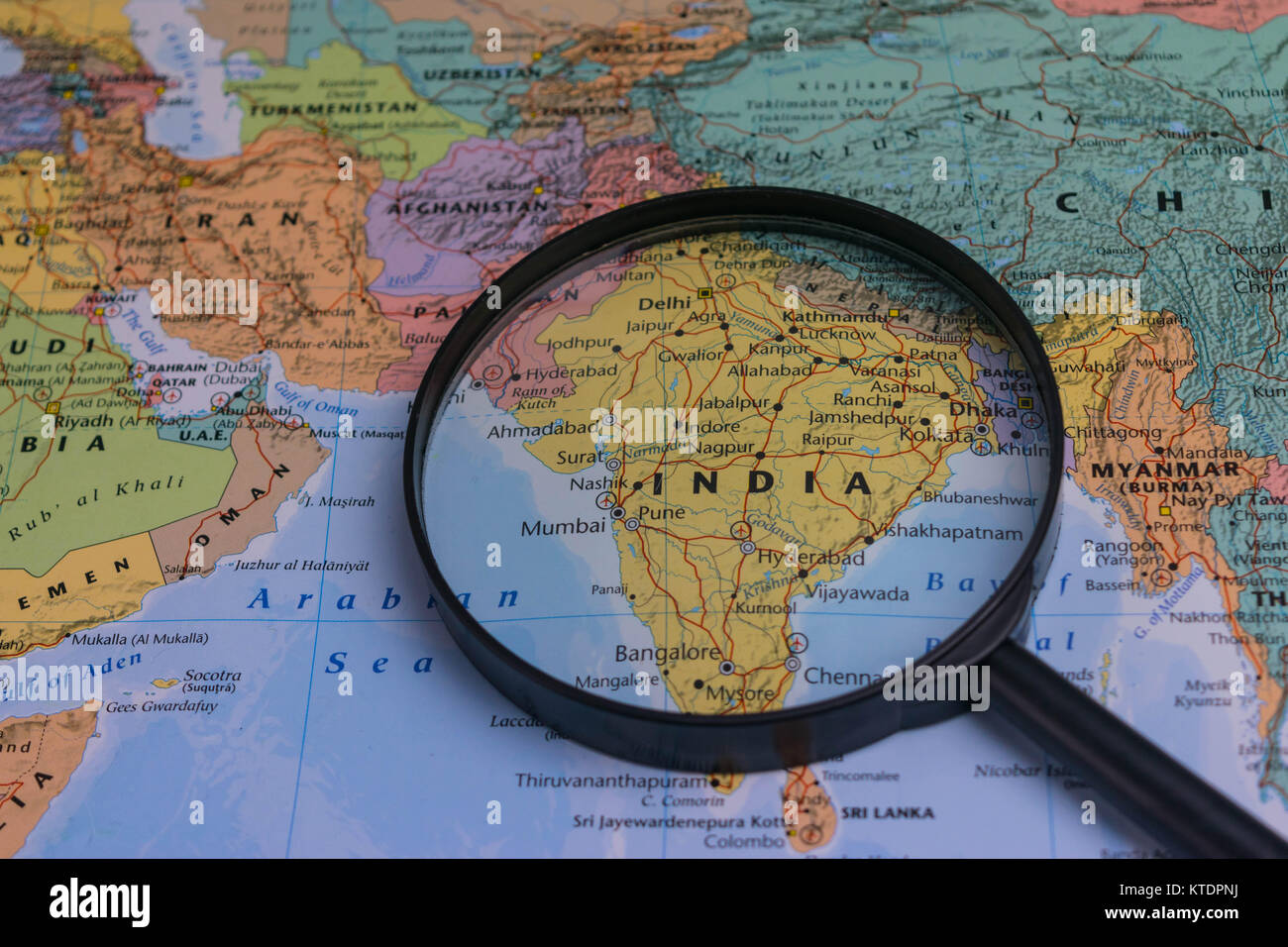 India map through magnifying glass on a world map Stock Photo