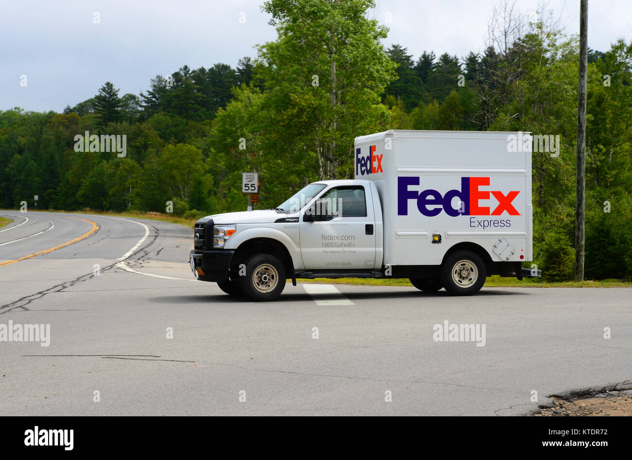 Small Federal Express FedEx delivery truck delivering packages in the remote Adirondack Wilderness. Stock Photo