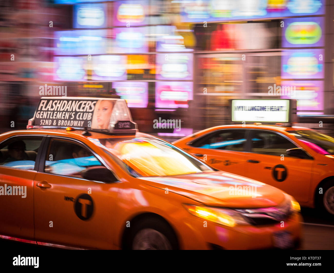 NEW YORK TIME SQUARE PANNING YELLOW TAXI BILLBOARD REFLECTIONS Stock Photo