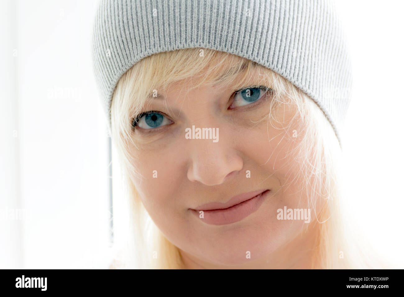 horizontal portrait of blond woman with blue eyes in grey hat Stock ...