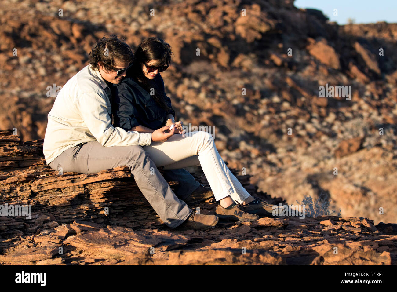 Young couple in  Damaraland sharing romantic moment - Huab Under Canvas, Damaraland, Namibia, Africa Stock Photo