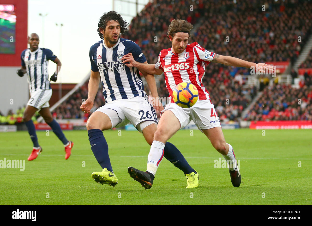 West Bromwich Albion's Ahmed Hegazy (left) and Stoke City's Joe Allen battle for the ball during the Premier League match at the Bet365 Stadium, Stoke. Stock Photo