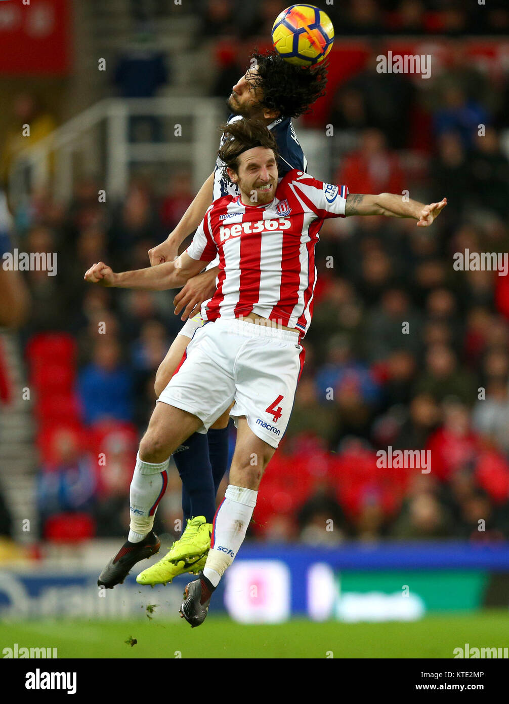 Stoke City's Joe Allen and West Bromwich Albion's Ahmed Hegazy battle for the ball during the Premier League match at the Bet365 Stadium, Stoke. Stock Photo