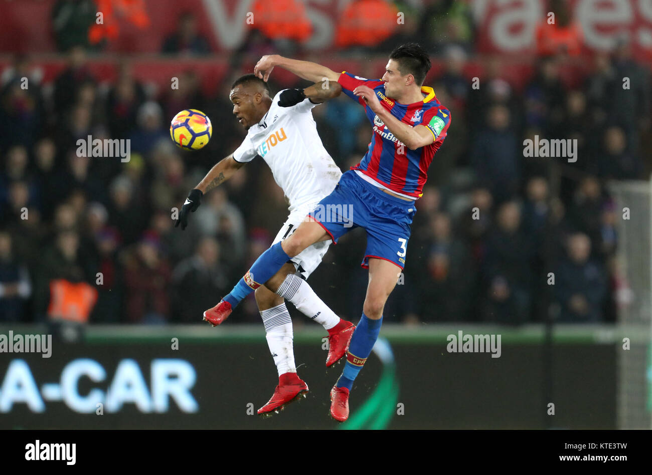 Crystal Palace's Martin Kelly (right) and Swansea City's Jordan Ayew battle for the ball during the Premier League match at the Liberty Stadium, Swansea. Stock Photo