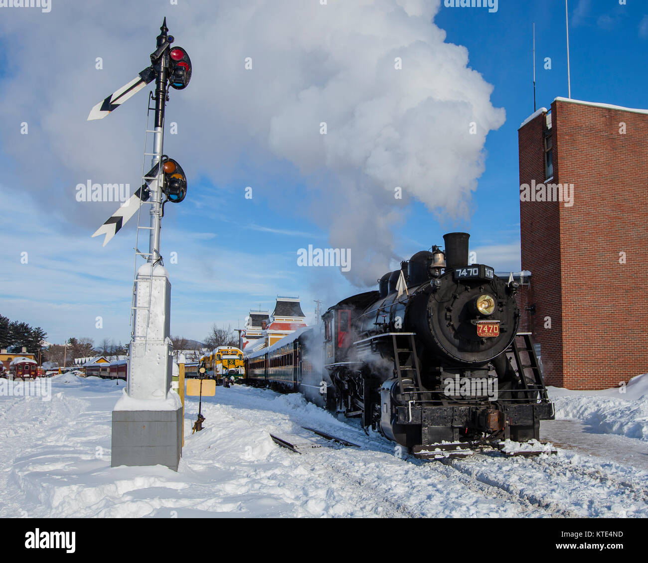 Steam engine in snow with railroad signal Stock Photo