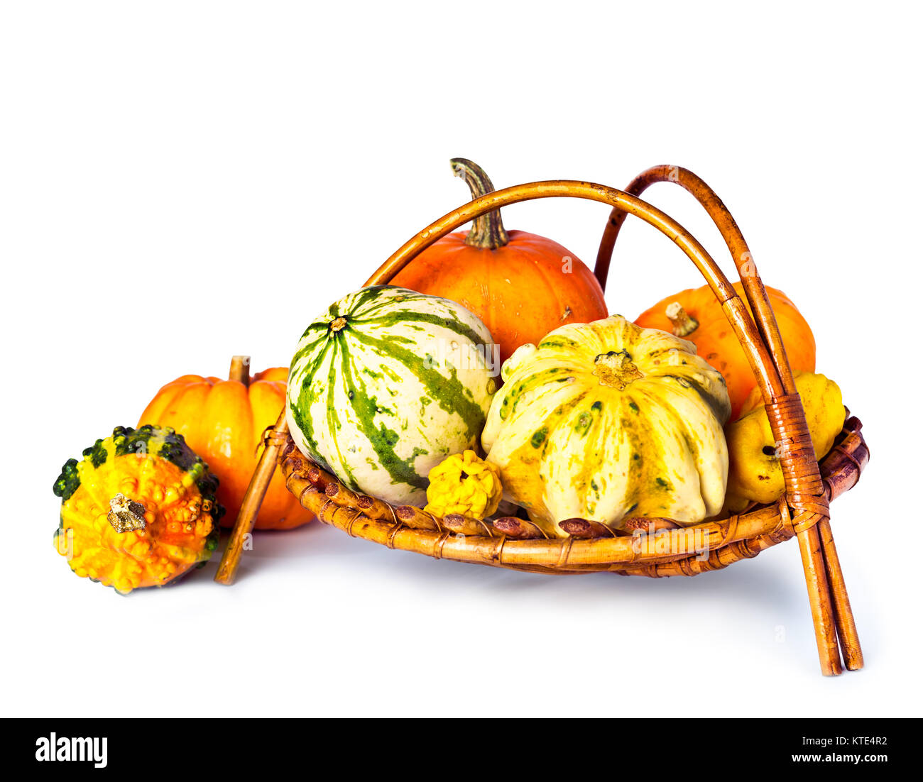 Basket of decorative pumpkins on white background Stock Photo - Alamy