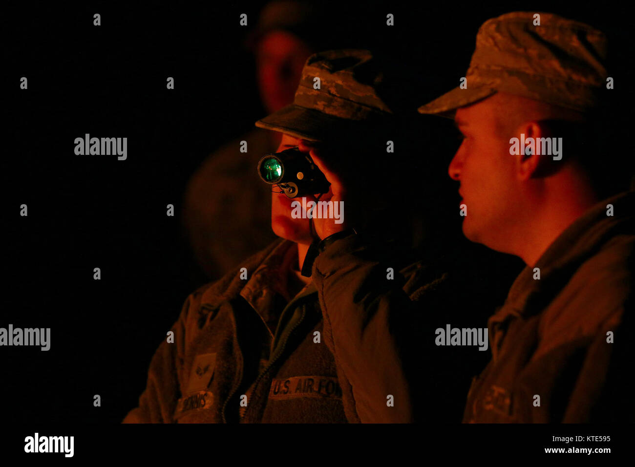 WRIGHT-PATTERSON AIR FORCE BASE, Ohio – Senior Airman Paula Dennis (left) and Senior Airman Tyler Acevedo, 445th Security Forces Squadron, test out night vision goggles during training at the Oakes Quarry, Fairborn on May 6, 2017.   The three-day expeditionary training consisted of several phases to include: Humvee mount/dismount, SERE, setting up/tear down tents, and night vision goggles. Stock Photo