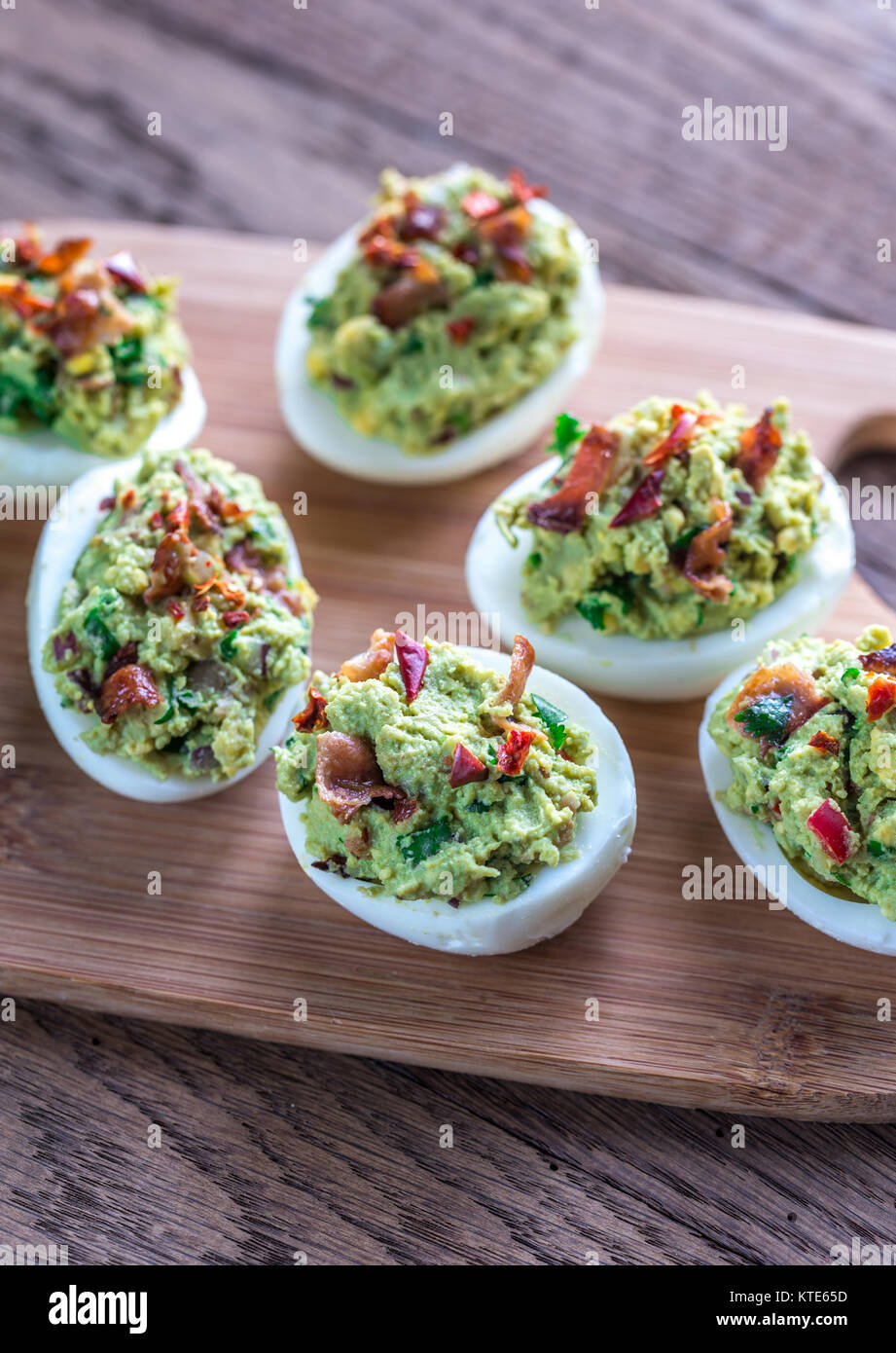 Bacon guacamole deviled eggs Stock Photo