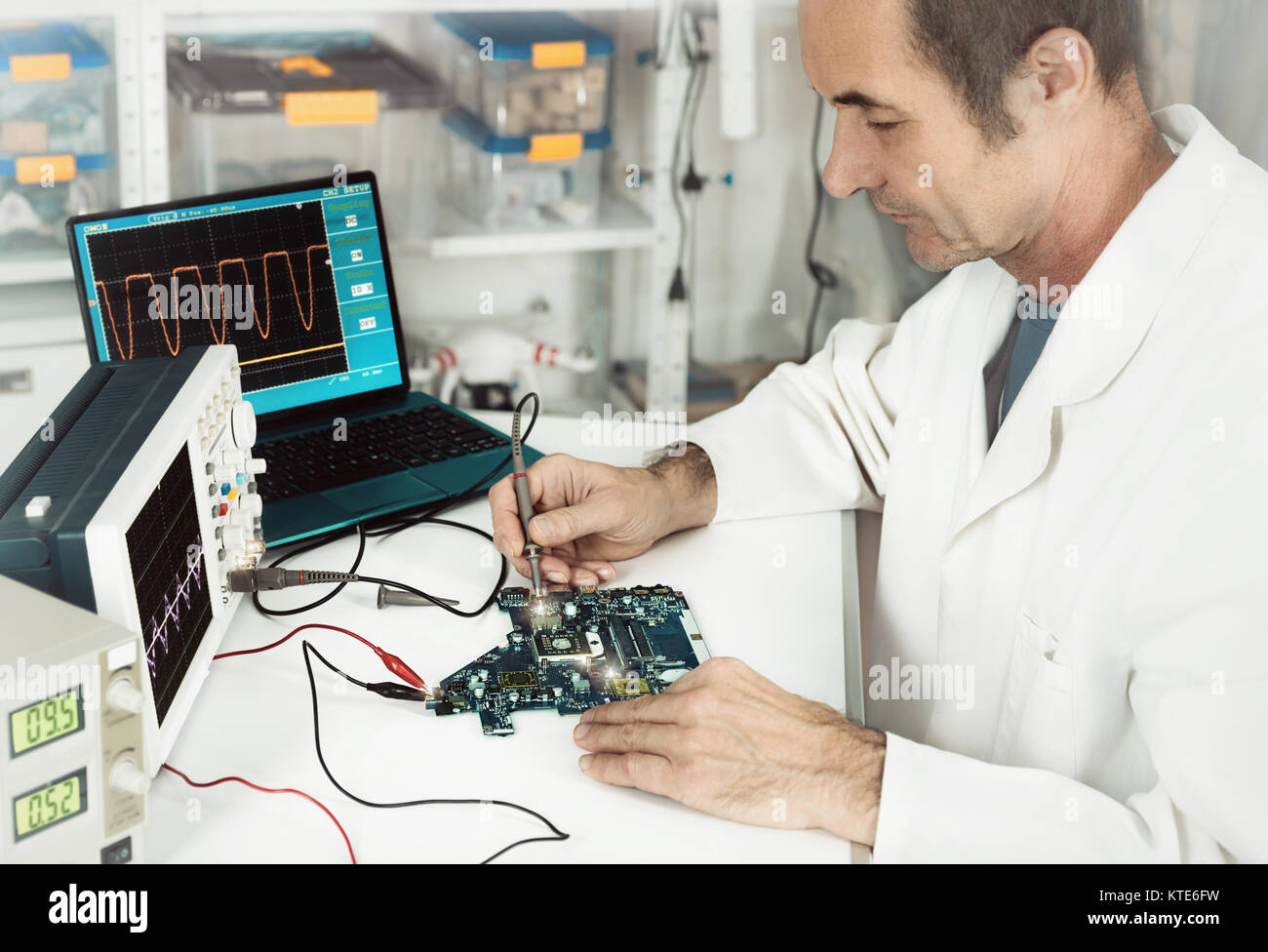 Senior male tech works in hardware repair facility. This image is toned