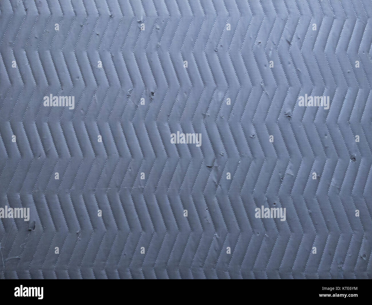 quilted angle lines on cool gray moving blanket Stock Photo Alamy