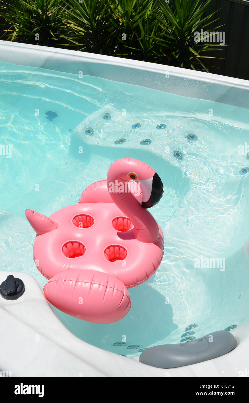 Pink flamingo drink holder floating in swim spa Stock Photo - Alamy