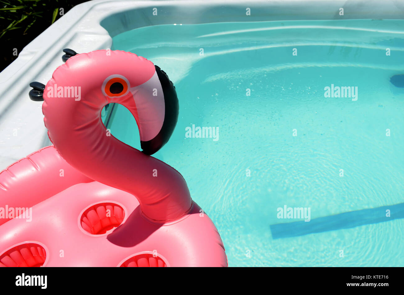 Pink flamingo drink holder floating in swim spa Stock Photo - Alamy