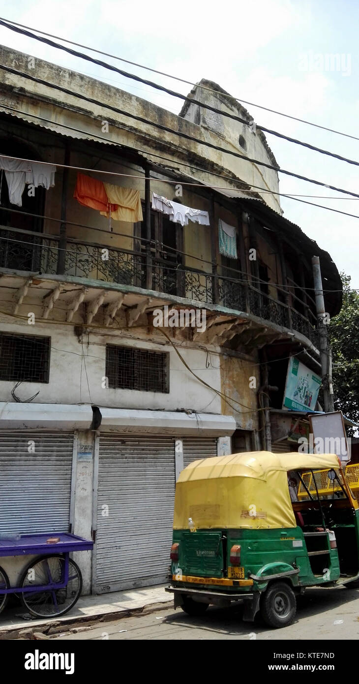Auto rickshaw in front of building in New Delhi India Stock Photo