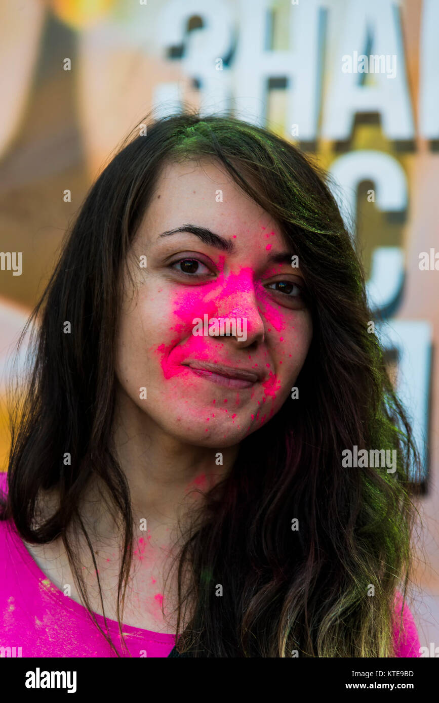 Lviv, Ukraine - August 30, 2015: Girl have fun during the festival of color in a city park in Lviv. Stock Photo