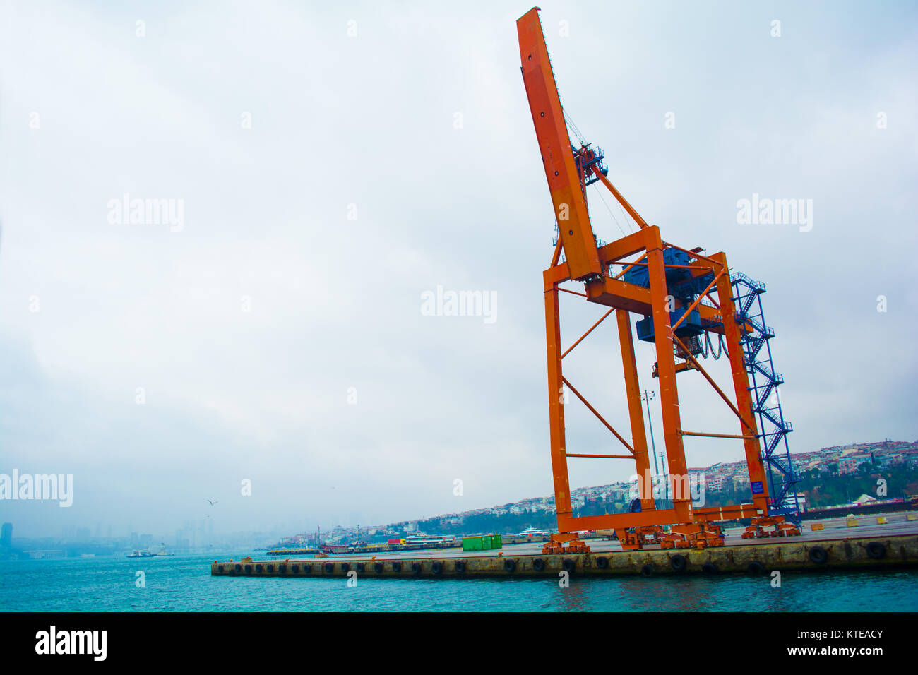 mechanical crane lifting freight at pier in istanbul turkey Stock Photo