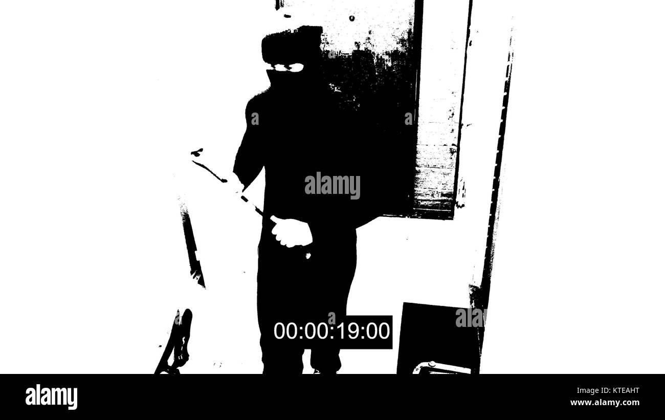 the robber in the mask c has a crowbar in his hands were under camera surveillance threshold effect Stock Photo
