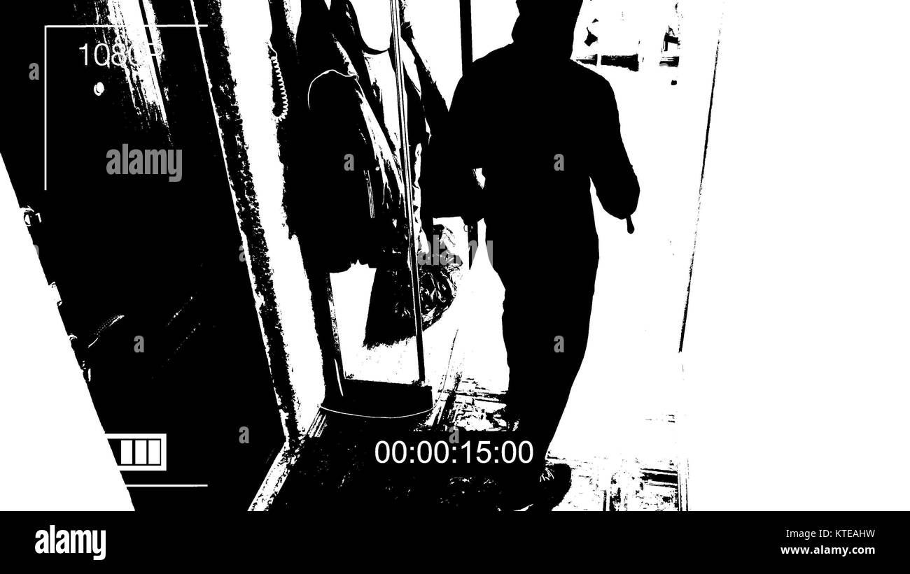 the robber in the mask c has a crowbar in his hands were under camera surveillance threshold effect Stock Photo