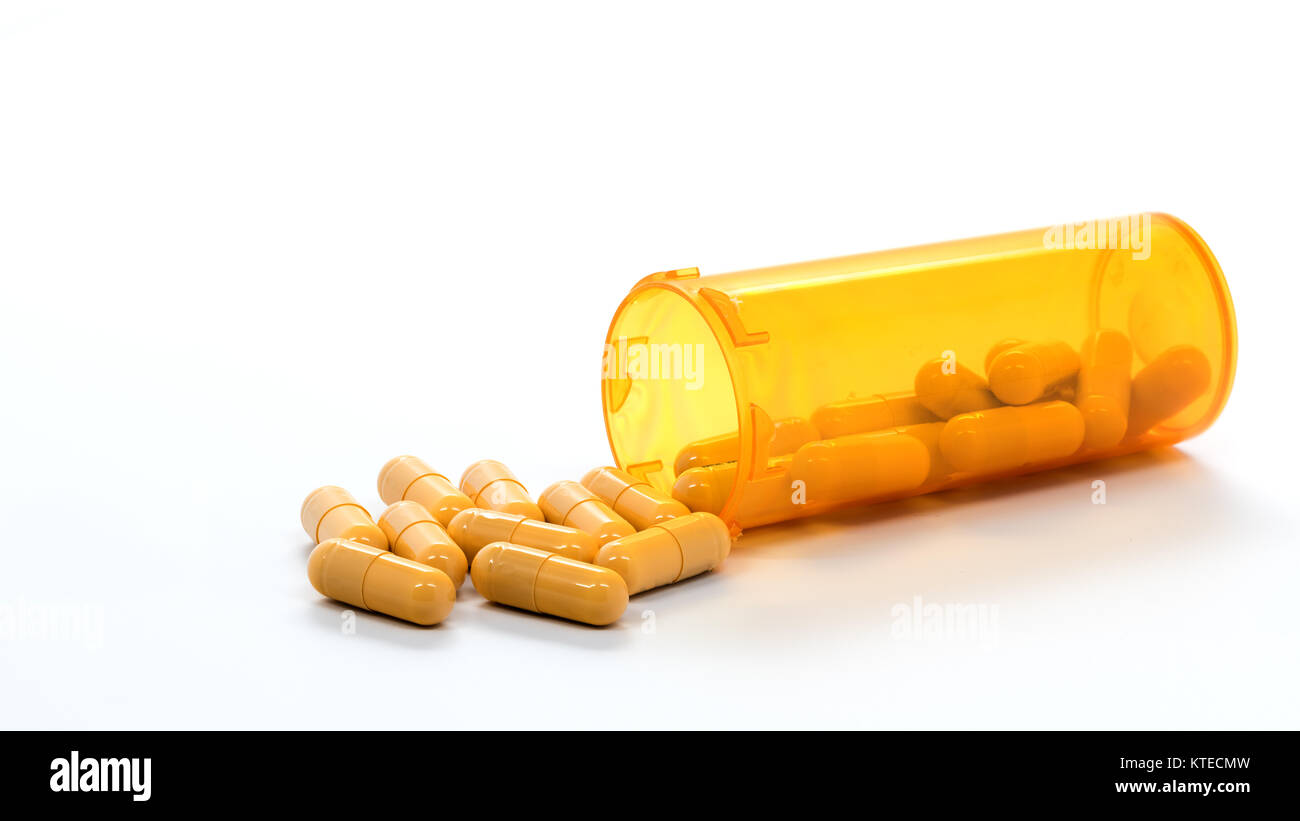 Orange pill bottle with yellow medication capsules Stock Photo Alamy