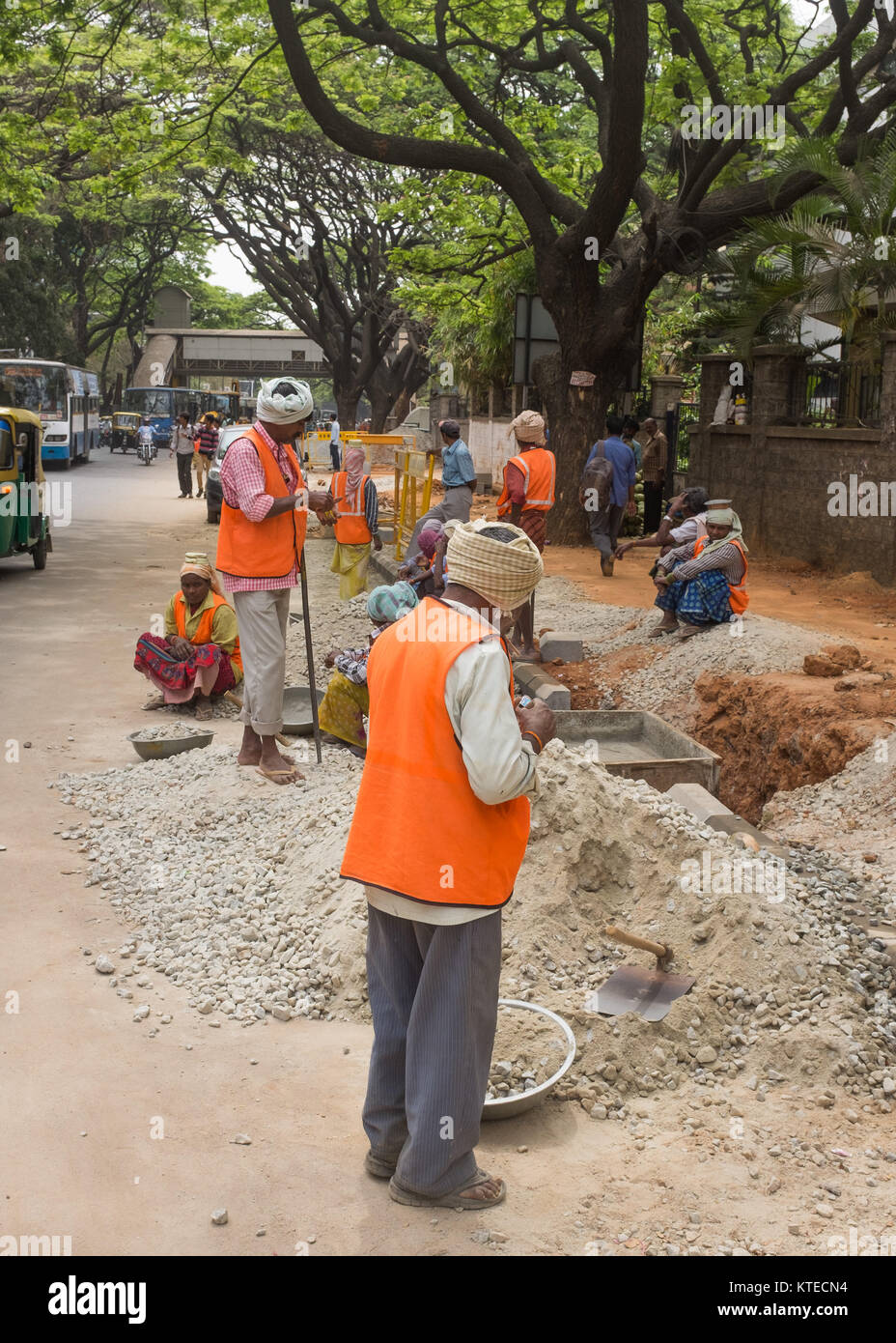 Construction workers on roadside, Bangalore, Karnataka, India. Stock Photo