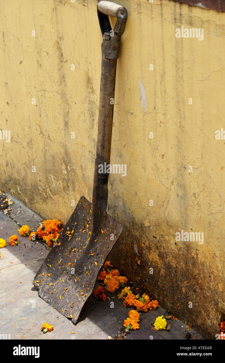 Shovel leaning against wall Stock Photo